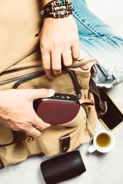 A stylish travel backpack with multiple compartments, hidden pockets, and RFID-blocking technology. The backpack is being packed with travel essentials like a passport, wallet, and phone.
