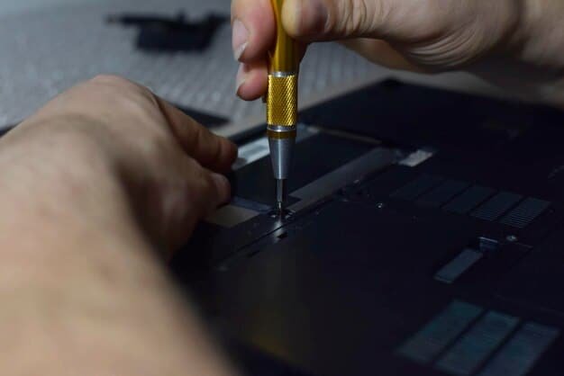 A close-up shot of a person using a small screwdriver to repair the motherboard of a laptop. The focus is on the intricate components and the precision required for such repairs.