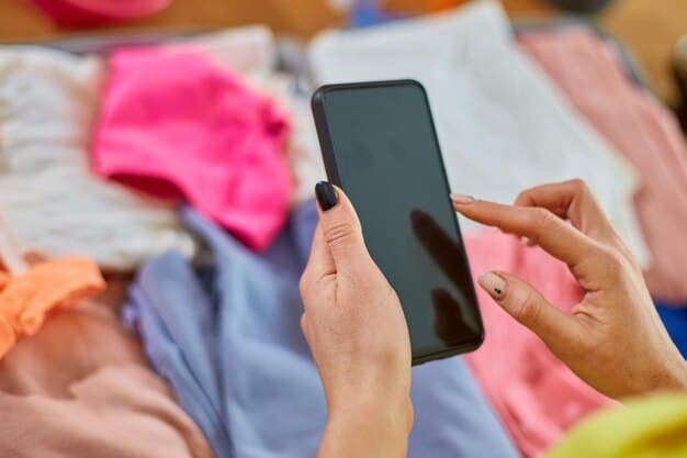 A close-up shot of a smartphone screen displaying an online resale marketplace. The screen showcases various secondhand clothing items listed for sale, with clear pricing and product details.