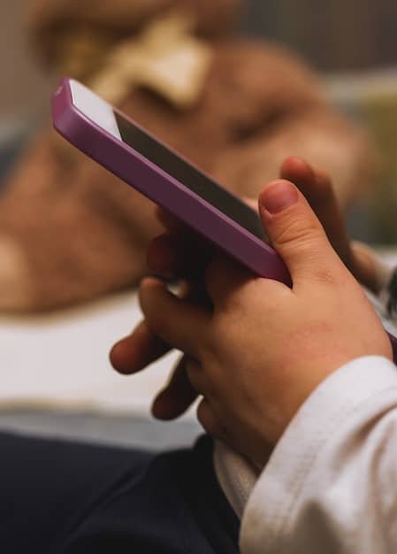 Close-up of a person's hands holding a smartphone, scrolling through a list of product reviews. The focus is on the screen and the intent expression of the person, highlighting the active engagement with review content.