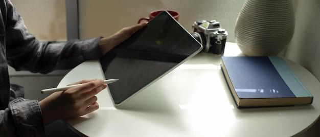 A person scrolling through luxury product reviews on a tablet, with a notebook and pen nearby, suggesting careful consideration and research. The ambiance is calm and focused.