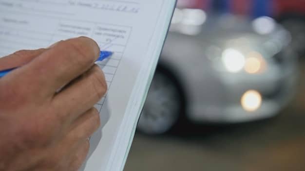 A close-up shot of a document outlining the specific requirements and guidelines for electric vehicle tax credits in 2025. The document includes details on income limits, vehicle eligibility, and the claiming process.