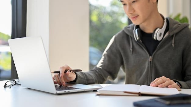 A close-up shot of a young professional participating in an online course on a laptop. The person is taking notes and appears highly focused. The background is blurred, with subtle office elements adding to the context.