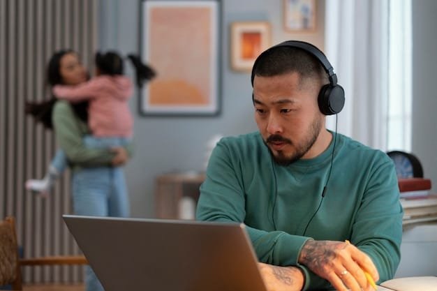 A person is on a video call, wearing noise-cancelling headphones. The setting is a bustling open office, with colleagues working in the background. The person appears calm and focused, highlighting the headphones' effectiveness in a busy work environment.