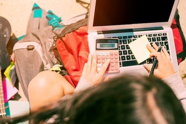 A person sitting at a desk, surrounded by flyers and online price comparison websites on a laptop, highlighting the act of comparing prices for back-to-school items.