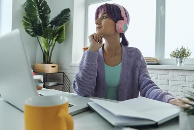 A person sitting at a desk, focused on a laptop screen, with a headset on. The background is a home office environment, showcasing the flexibility of online learning. There are motivational quotes and books on the desk.